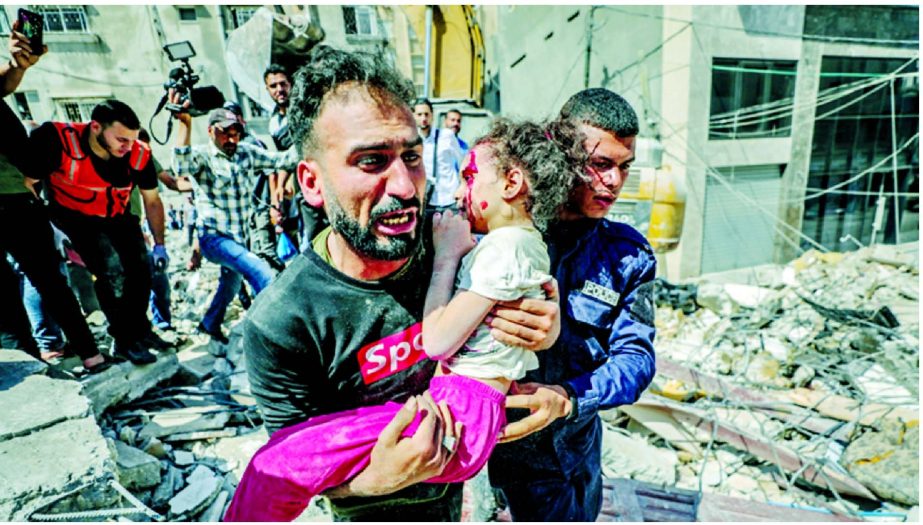 A Palestinian rescuer screams after recovering a wounded child from the rubble of a destroyed building in Gaza City's Rimal residential district on 16 May 2021, following massive Israeli bombardment on the Hamas-controlled enclave.