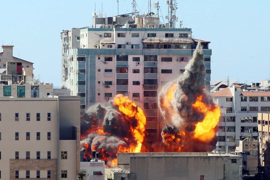 The al-Jalaa building housing Associated Press (AP) and Al Jazeera media offices is hit by an Israeli air strike in Gaza City.