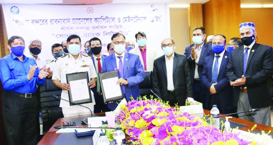 Md Ataur Rahman Prodhan, CEO and Managing Director of Sonali Bank Limited and Humayun Kallol, Chairman of Payera Port Authority, exchanging document after signing a loan agreement on Tuesday at the bank's head office on Tuesday. Under the deal, the Payra