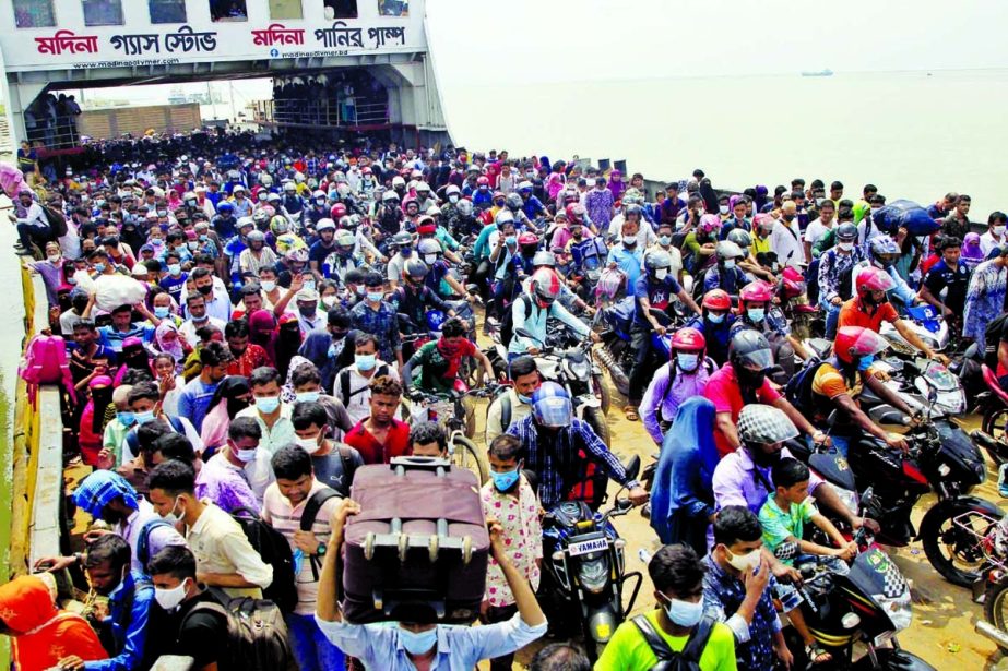 Thousands of people on a ferry rush towards Dhaka after Eid vacation risking corona infection at Mawa ghat on Wednesday.