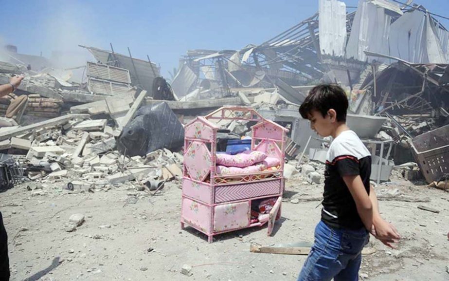 A Palestinian boy near the ruins of his house after an Israeli airstrike in Gaza City, Gaza Strip, May 14, 2021. Civilian deaths on both sides raise urgent questions about which military actions are legal, what war crimes are being committed and who, if a
