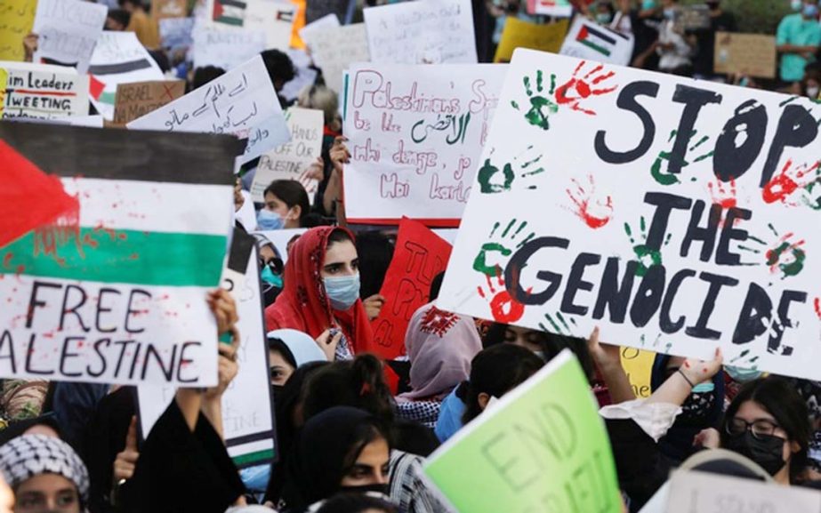 Students carry signs as they chant slogans to express solidarity with Palestinian people, during a protest organized by the Students Action Committee in Karachi, Pakistan.