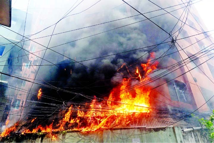 Members of Fire Service trying to douse fire that broke out suddenly at Rupayon Tower of Segun Bagicha area in the capital on Friday