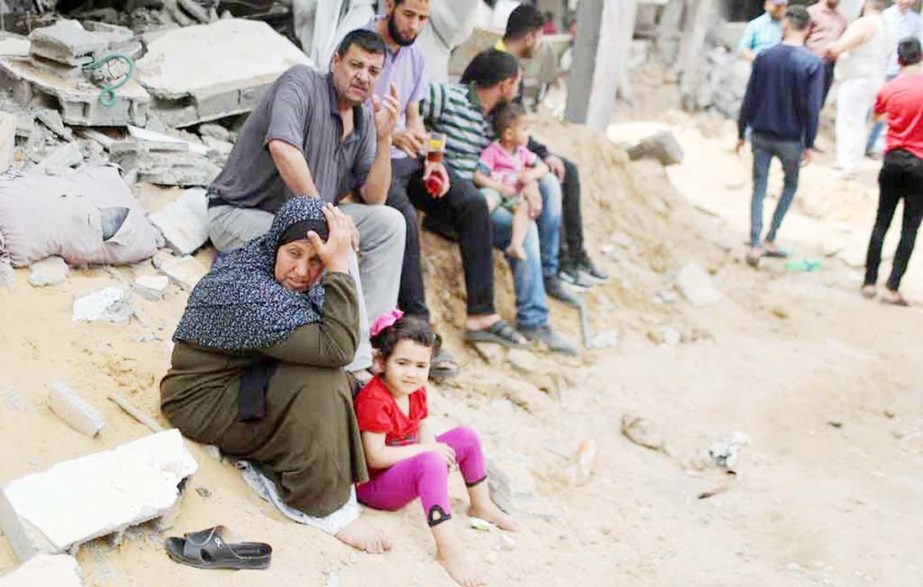 A Palestinian woman reacts after returning to her destroyed house following Israel-Hamas truce, in Beit Hanoun in the northern Gaza Strip.