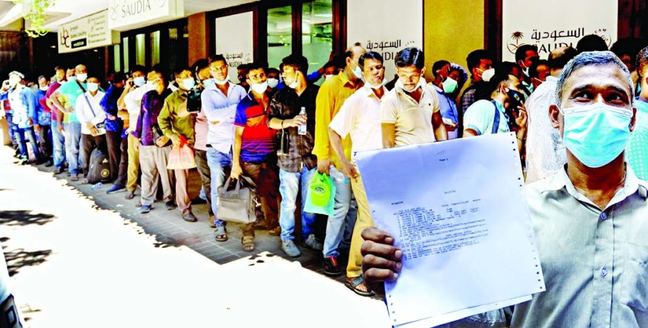 A Saudi Arabia bound Bangladeshi migrant worker shows the receipt of hotel reservation for institutional quarantine in the Gulf country while standing in a queue at the Saudi Airlines' Dhaka office on Saturday.