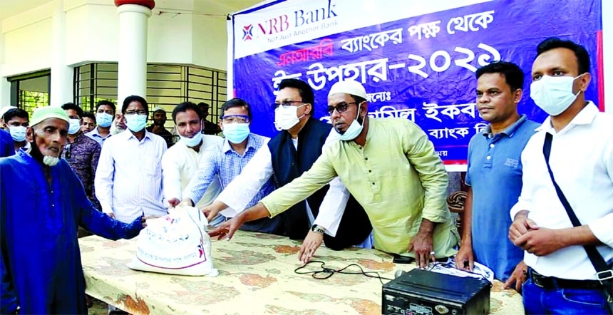 Mohammed Zamil Iqbal, Vice Chairman of the NRB Bank Limited, distributing essential food items among the under privileged people at Biyanibazar Upozila of Sylhet recently. Mohammed Jahed Iqbal, Director of the bank and Sarwar Hossain, Senior Member of Syl