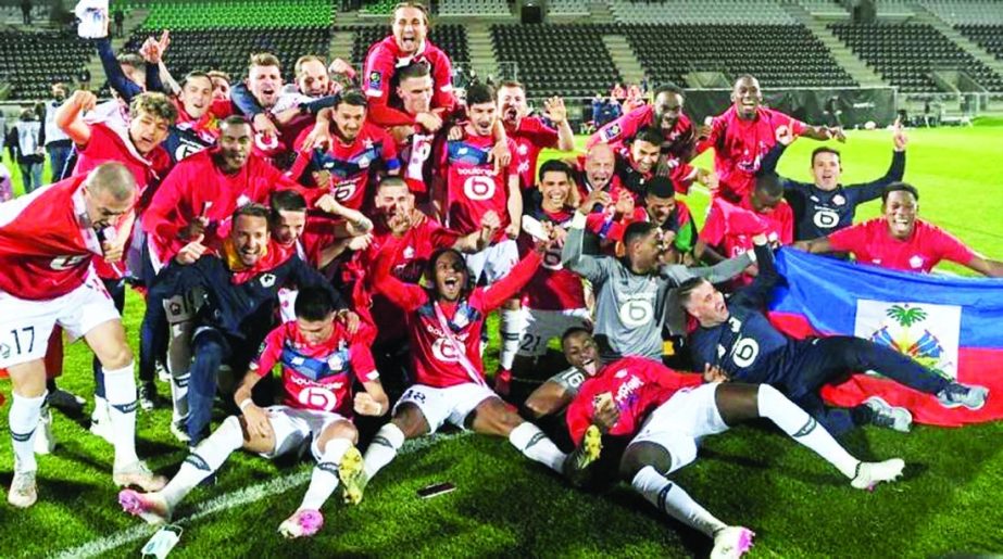 Lille's players pose for a group picture after winning the French L1 football match against Angers SCO and also winning the league at the Raymond-Kopa Stadium in Angers, north-western France on Sunday.