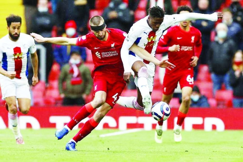 Liverpool's defender Nathaniel Phillips (left) vies with Crystal Palace's striker Wilfried Zaha during the English Premier League football match at Anfield in Liverpool, North West England on Sunday.