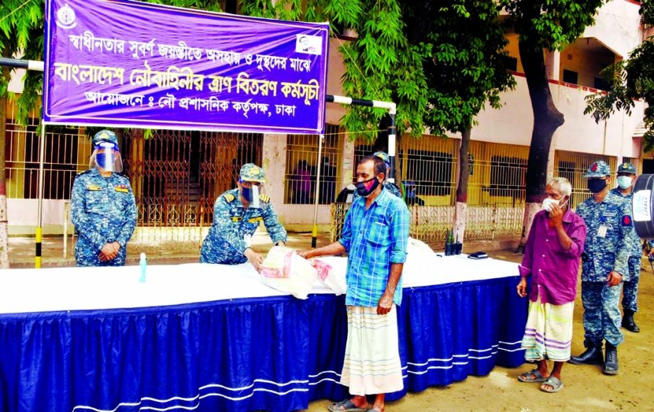 Naval forces distributes foodstuff among the destitute in the city's Khilkhet area on Tuesday during corona pandemic. SPR photo