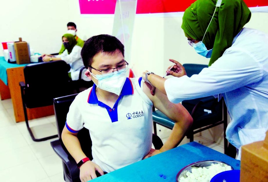 A Chinese expatriate living in Bangladesh receives Sinopharm's Covid vaccine at Dhaka Medical College Hospital on Saturday.