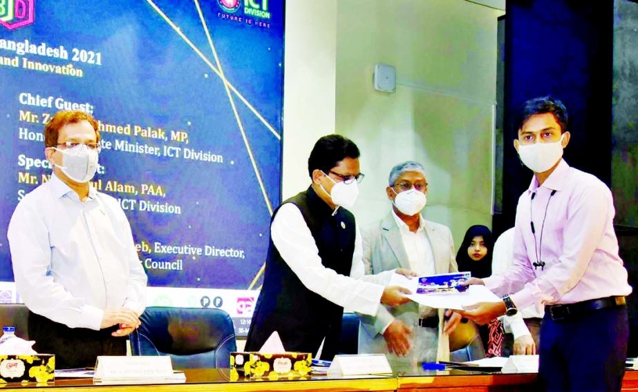 State Minister for Information and Communication Technology (ICT) Zunaid Ahmed Palak hands over prizes among the participants of 'Blockchain Olympiad Bangladesh 2021' held Bangladesh Computer Council auditorium at Agargaon in the capital on Sunday.