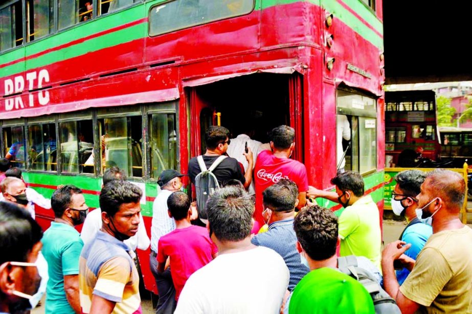 People scramble to get in a BRTC buys in the capital on Sunday, health rules are hardly care for.