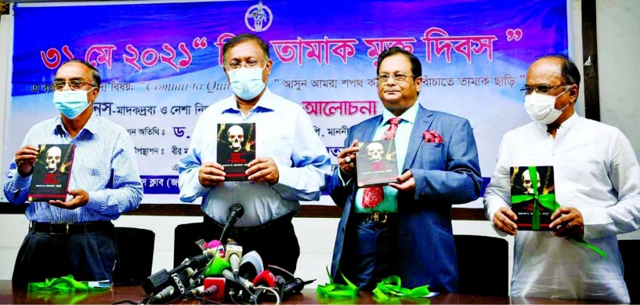 Information and Broadcasting Minister Dr. Hasan Mahmud, among others, holds the copies of a book titled 'Drug Addict from Smoking' written by Dr.Arup Ratan Chowdhury at its cover unwrapping ceremony at the Jatiya Press Club on Monday marking World Tobac
