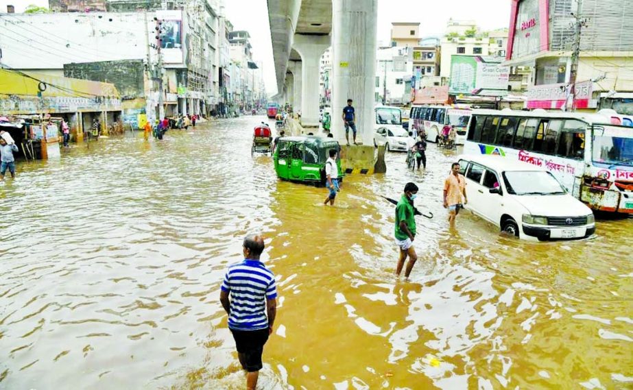 Motor vehicles struggling to move on a waterlogged Dhaka road after pre-monsoon heavy showers lashed the city on Tuesday.