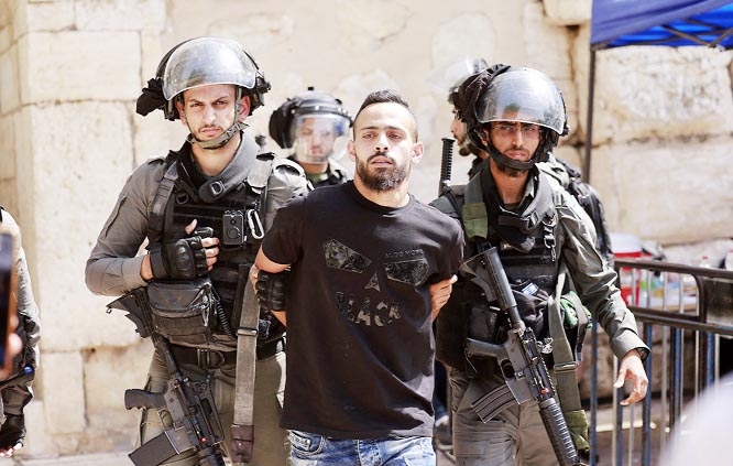 Israeli security forces detain a man at the entrance of Jerusalem's al-Aqsa mosque compound.
