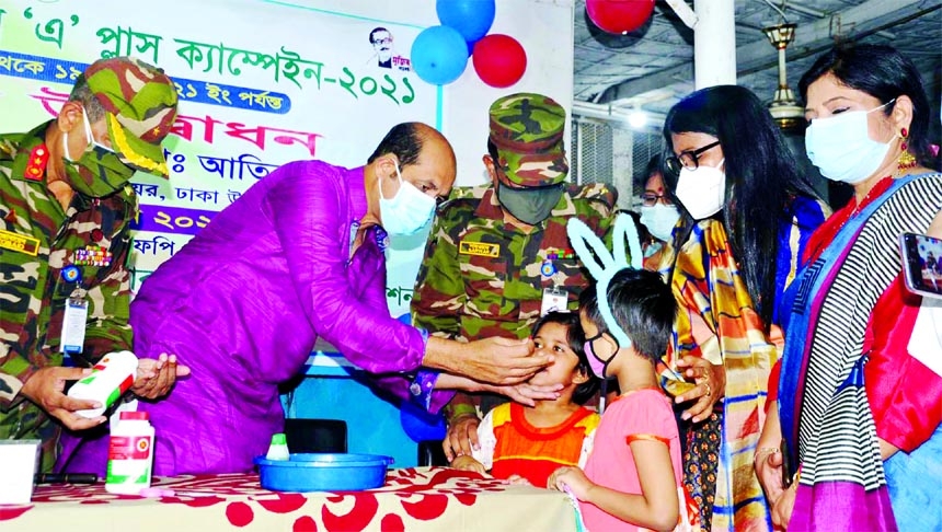 DNCC Mayor Atiqul Islam inaugurates Vitamin 'A' Plus Campign-2021 administering a capsule to a child in the city 's Mirpur on Saturday.