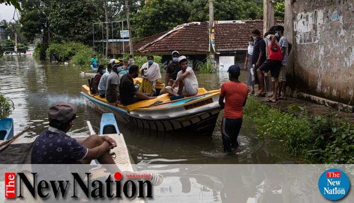 Stranded Sri Lankans travel in a boat in an inundated street following heavy rainfall in Malwana, on the out skirts of Colombo, Sri Lanka, Saturday, June 5, 2021. Flash floods and mudslides triggered by heavy rains in Sri Lanka have killed at least four p