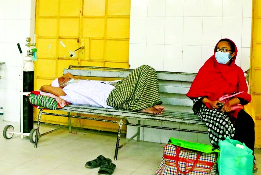 A patient lying on a bench with oxygen support at Rajshahi Medical College Hospital on Sunday during Coronavirus surge. He awaits admission.