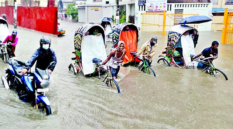 People on different modes of transport wade through waist-deep water on a flooded road in Chattogram's Muradpur area on Sunday. Hours of incessant rain leave large part of the port city inundated, causing untold sufferings to people.
