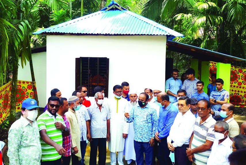 To rehabilitate the landless family of Swapon Banik, a resident of 6 no. ward of Betagi Municipality, Additional Secretary Shamol Chandra Sarker hands over key of the new home to the family members.