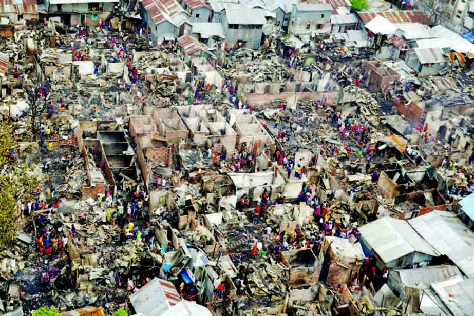 Slum dwellers search for their belongings from ashes after fire gutted their shelters at Mohakhali slum in Dhaka. Seven incidents of fire occured in last three years at the slum.