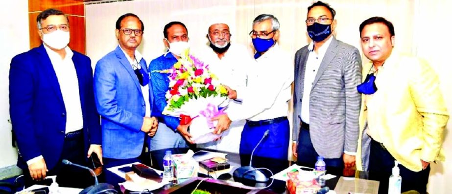 S M Mannan (Kochi), Senior Vice-President of the Bangladesh Garment Manufacturers and Exporters Association (BGMEA), greeting Kazi Mustafizur Rahman, newly appointed Commissioner of the Customs Bond Comissionarate, Dhaka, by handing over bouquet at the la