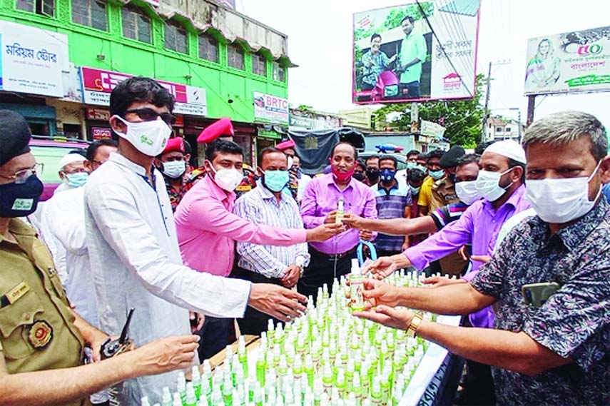 Photo shows Directorate of Narcotics Control Chandpur distributes hand sanitizers among people and passers-by in Bus Stand, Kalibari More and Railway Station areas in Chandpur town on Wednesday. Deputy Director of Local Govt and ADC General Abdu