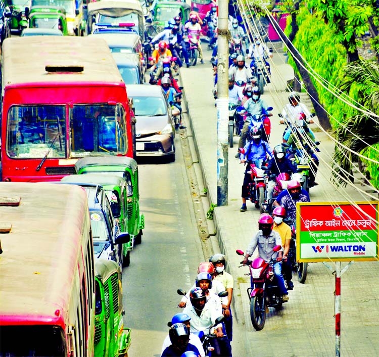 Bikers move to and fro footpath to sidetrack traffic jam violating traffic rules at Satrasta of Tejgaon in the capital on Thursday.