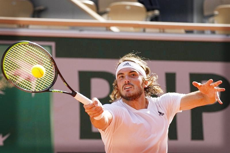 Stefanos Tsitsipas of Greece slams a forehand to Germany's Alexander Zverev (not in frame) during their semifinal match of the French Open tennis tournament at the Roland Garros stadium in Paris, France on Friday.