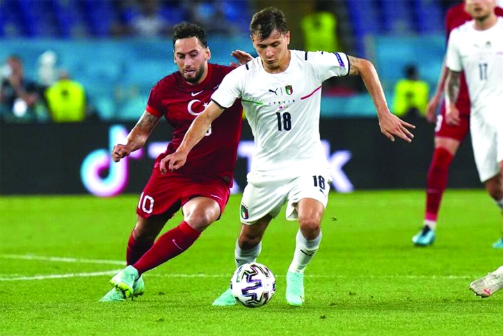 Turkey's Hakan Calhanoglu (left) and Italy's Nicolo Barella vie for the ball during the Euro 2020 Group A soccer match between Italy and Turkey at the Rome Olympic stadium on Friday.