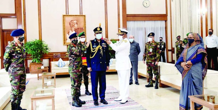 Quartermaster General SM Shafiuddin Ahmed and Assistant Chief of Naval Staff (Operations) Rear Admiral M Abu Ashraf adorn the new rank badge to the newly-appointed Chief of Air Staff Air Marshal Sheikh Abdul Hannan in presence of Prime Minister Sheikh Has