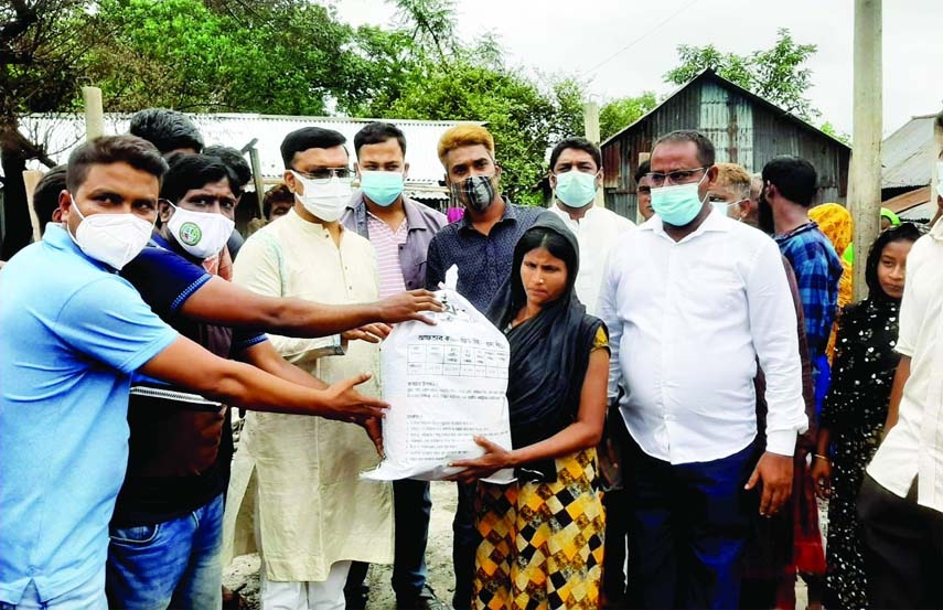 Mymensingh City Corporation Mayor Md. Ekramul Haque Titu on Monday distributes food items among the families affected by the fire in Islambagh slum under MCC area.