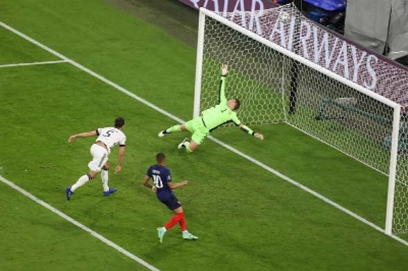 Germany's defender Mats Hummels (left) deflects the ball to score past Germany's goalkeeper Manuel Neuer for the first goal during the UEFA EURO 2020 Group F football match between France and Germany at the Allianz Arena in Munich on Tuesday.