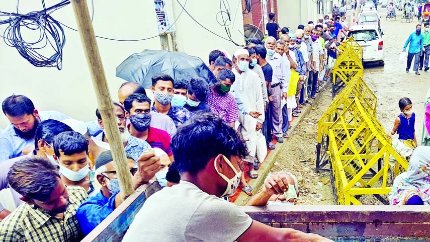 Customers stand in a long queue to buy TCB's OMS sale products in front of the Jatiya Press Club on Thursday as price of daily necessities going up day by day.