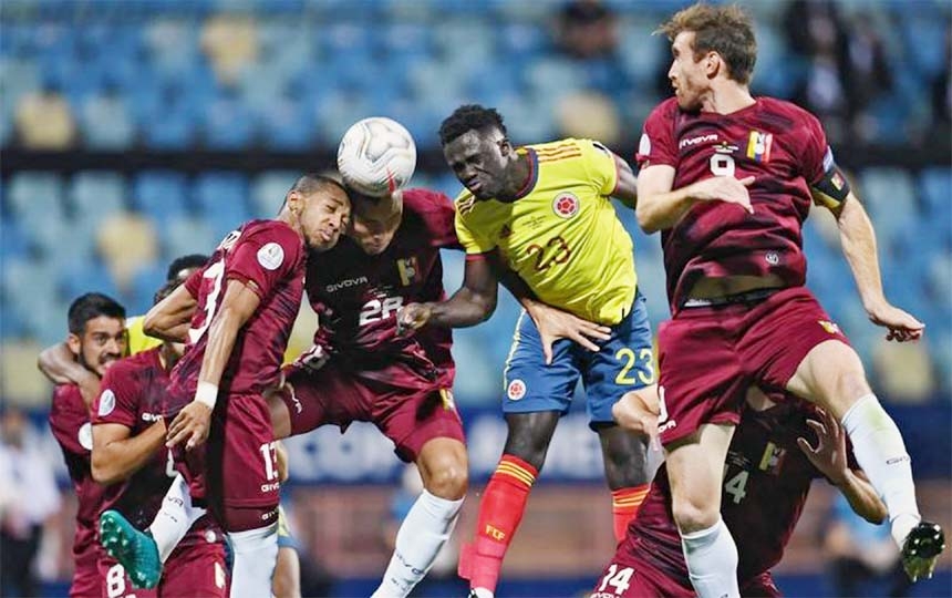 Venezuela's Jose Martinez (left) teammate Luis Martinez and Colombia's Davinson Sanchez jump for a header during their Copa America 2021 football tournament group phase match at the Olympic Stadium in Goiania, Brazil on Thursday.