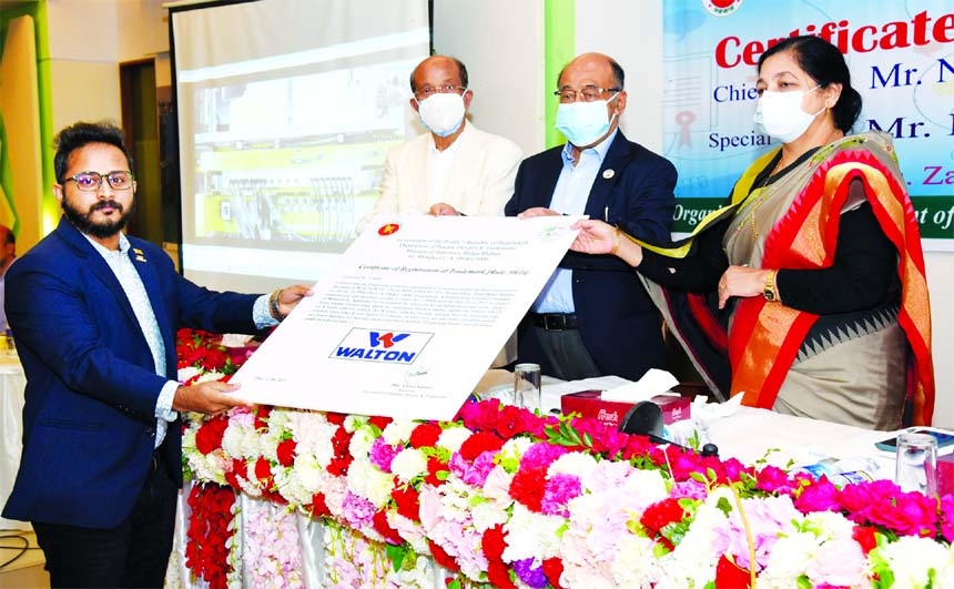 Engineer Golam Murshed, Managing Director of Walton Hi-Tech Industries Limited, receiving the trademark certificate from Industries Minister Nurul Majid Mahmud Humayun, at a function held on the occasion of 'World Intellection Property Day' at Officers