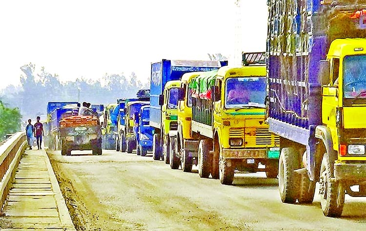 Vehicles get stuck in a long traffic jam on Bangabandhu Bridge in Sirajganj on Friday due to repair work on a nearby bridge.