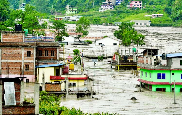 This general view shows houses submerged in flood waters in Sindhupalchok, some 70 km northeast of Kathmandu, Nepal.
