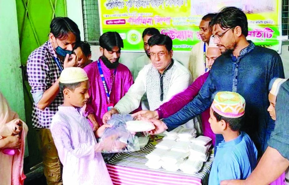 Joint Organising Secretary of Jatiya Party Central Committee Delwar Hossain Khan Milon distributes new dress and food among the orphan students of Mirpur Alimul Ulum Madrasa in the city on Saturday.