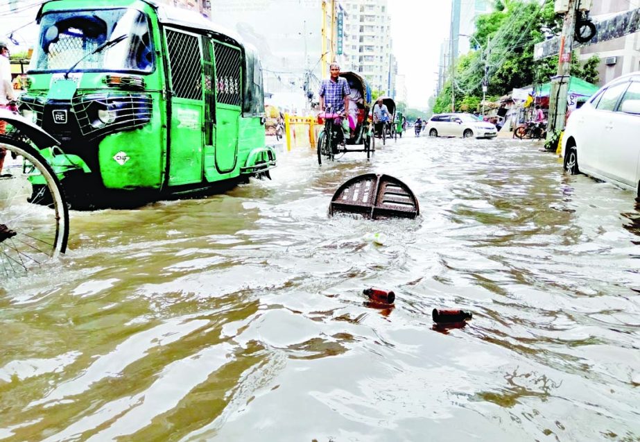 Vehicles wade through a waterlogged road after the moderate to heavy monsoon rainfall in the capital on Saturday.