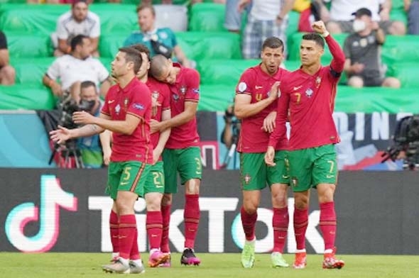 Portugal players celebrate after Portugal's forward Cristiano Ronaldo (right) scored their first goal during the UEFA Euro 2020 Group F football match between Portugal and Germany at Allianz Arena in Munich on Saturday. Germany won 4-2.