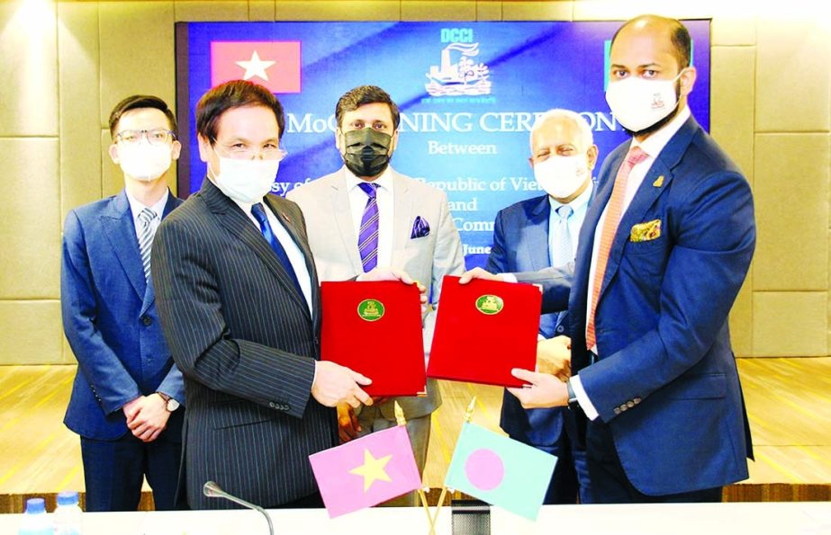 Rizwan Rahman, President of Dhaka Chamber of Commerce & Industry (DCCI), and Pham Viet Chien, Ambassador of Vietnam in Dhaka, exchanging documents after signing a Memorandum of Cooperation (MoC) to work jointly in order to foster both way trade and invest