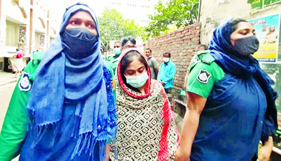 Police escort Mehzabin Moon to a Dhaka court yesterday seeking remand to interrogate her. She was arrested on Saturday for killing her parents and younger sister in Kadamtali, Dhaka.