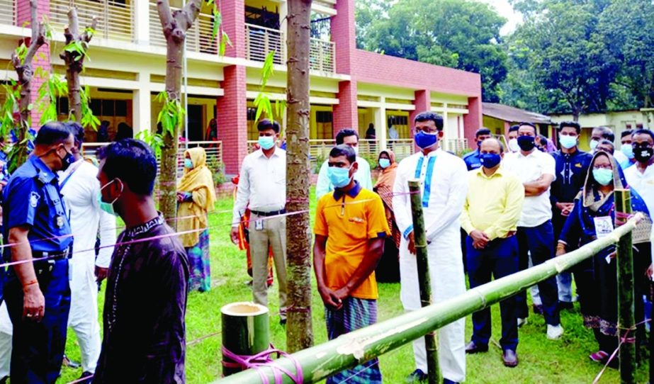 State Minister for Shipping Khalid Mahmud Chowdhury, among others, stands in long queue to cast vote for Setabganj Municipal election of Bochaganj Upazila in Dinajpur on Monday.