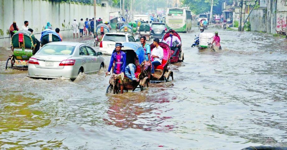 A road behind Bangabhaban in the capital inundates following heavy rain on Monday.