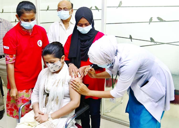 A nurse injects the Pfizer-BioNTech Covid-19 vaccine to a woman at BSMMU Hospital in Dhaka on Monday, June 21.