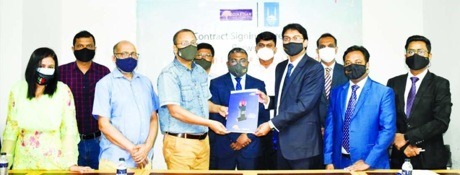 Sheikh Rakibul Karim, Acting CEO of Guardian Life Insurance Limited (GLIL) and Mohammad Akmal Shareef, Country Director of Islamic Relief Bangladesh (IRB), exchanging document after signing a group insurance agreement at GLIL head office in the capital re