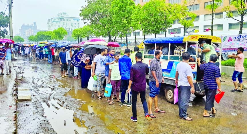 People stand in a long queue at Jurain area in the capital on Tuesday to on board Legunas to reach their respective work places.