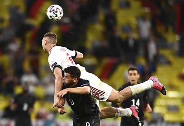 Hungary's Willi Orban (top) and Germany's Kevin Volland challenge for the ball during the Euro 2020 soccer championship group F match between Germany and Hungary at the Allianz Arena in Munich, Germany on Wednesday.