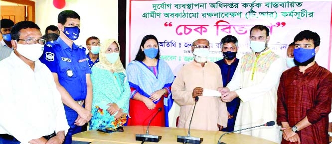 Gabtoli, Bogra Upazila Chairman Rafi Newaz Khan distributes cheques for Tk. 30 lakh for maintaining 35 projects of TR Fund financed by Department of Relief and Disaster Management held at Isamoti Halroom of the Upazila Parishad on Friday with Upazila Nirb